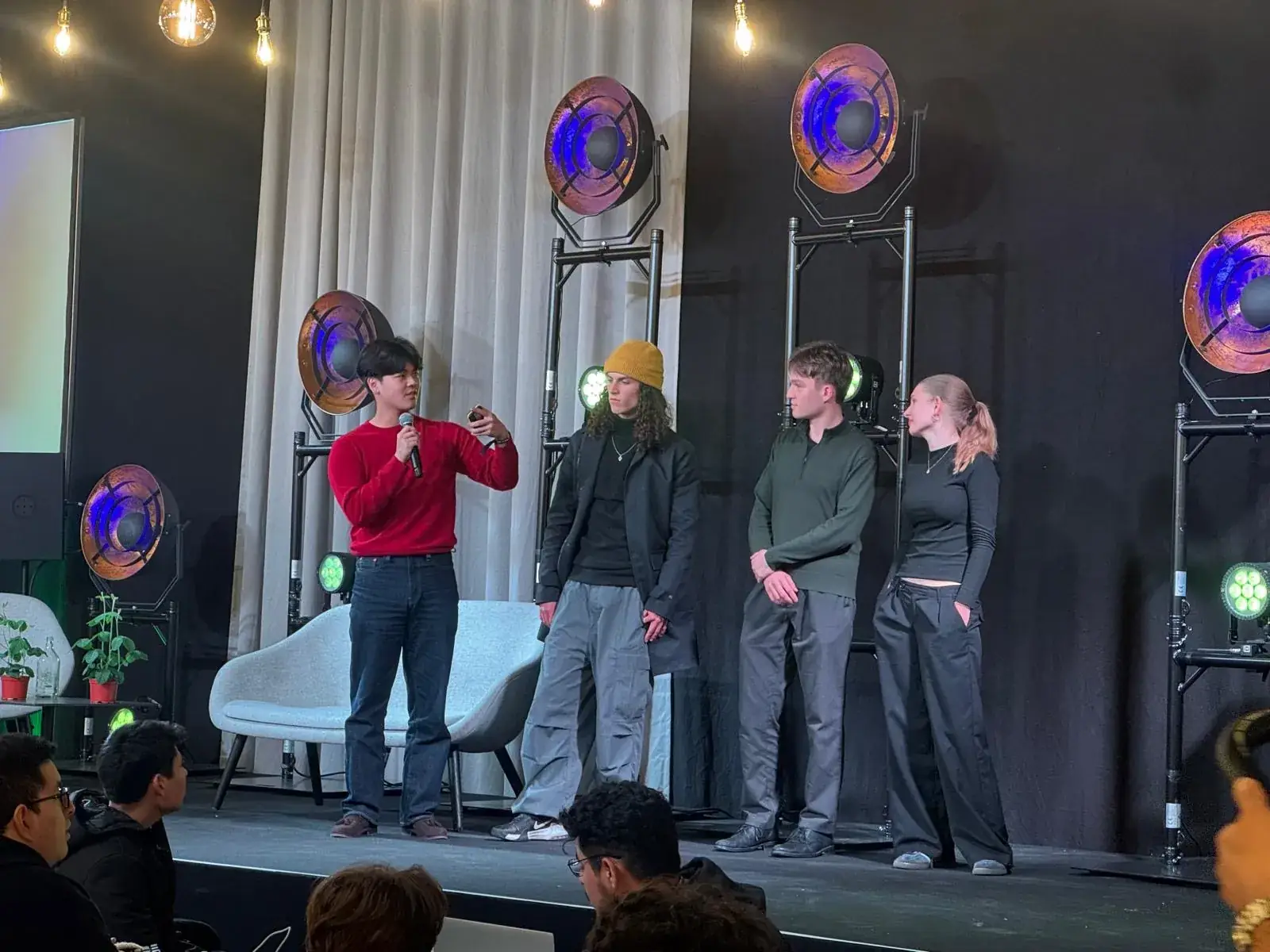 Felix Du on stage with his team answering questions