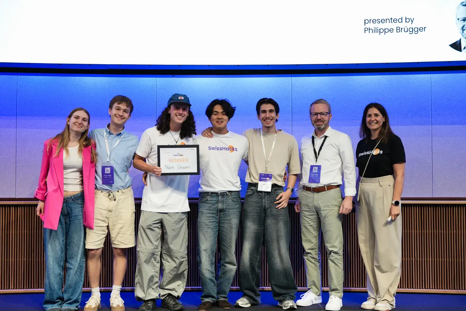 Felix Du and the Zetlar team on stage receiving the SwissHacks 2026 winners' certificate